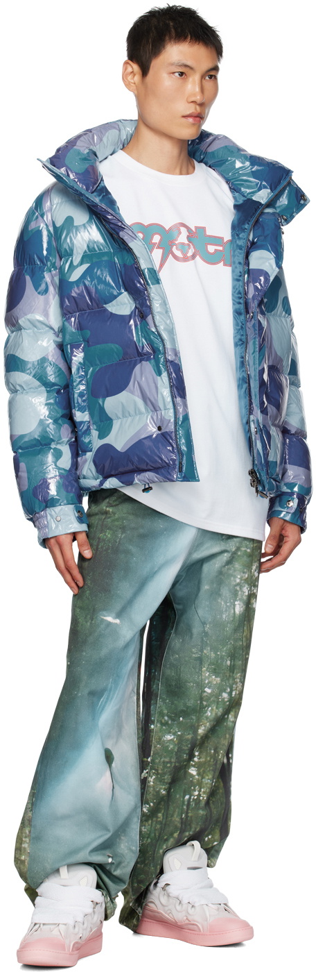 Members of the Rage — green forest-print jeans with MOTR tee and camo puffer